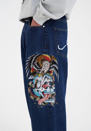 Calça jeans com estampa de tatuagem de cobra, caveira e águia - índigo